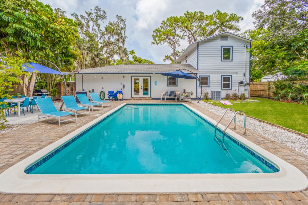 Large heated saltwater pool with outdoor dinning for 10 and plenty of seating options to relax and unwind.