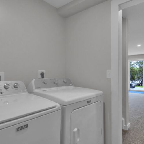Conveniently located beside the game room, the laundry area features a washer and dryer for your stay