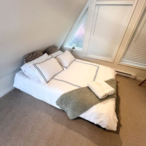 Queen Bed in the loft, this space also has a desk and a TV.