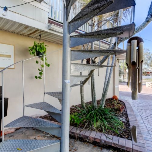 Spiral staircase to get up to the apartment.
