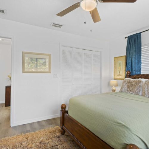 Full bedroom, fan, closet, blinds, curtains.