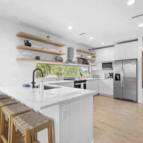 Sleek, modern, open-concept kitchen with spacious countertops, stainless steel appliances, and a bright, airy layout perfect for cooking and entertaining.