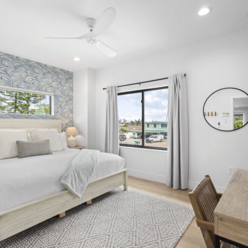 Bright king bedroom with scenic views, desk area, and a mounted TV for ultimate relaxation.
