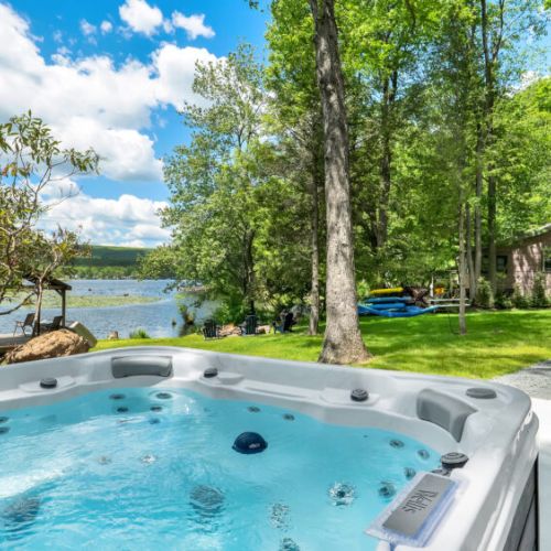 Soak in the hot tub while enjoying peaceful lake views.
