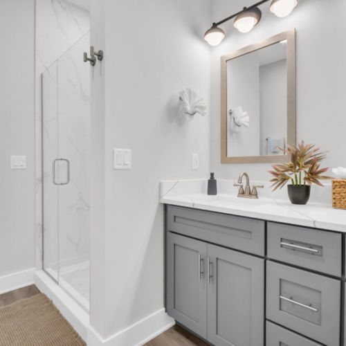 Queen Shell Room Ensuite Bathroom. Dual sinks and walk-in shower.