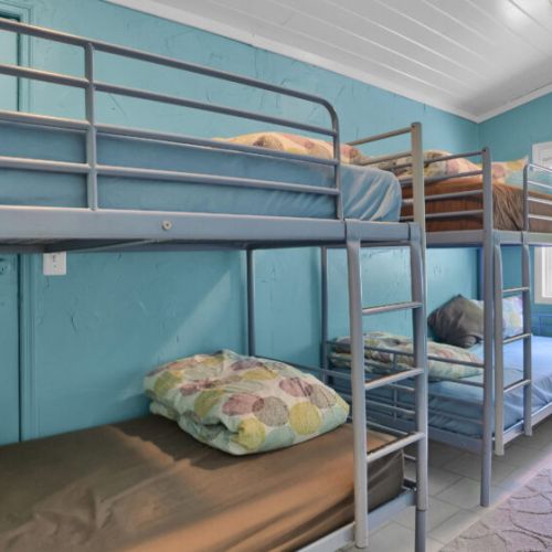 Kids and groups will love this space! A bright and charming bedroom featuring sturdy bunk beds and plenty of natural light.