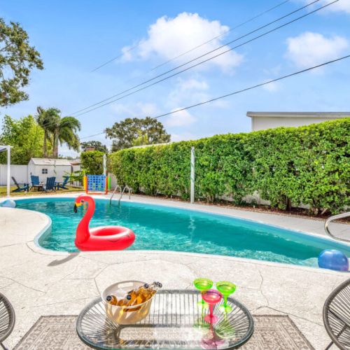 POV: You are in the spacious heated pool relaxing on a pink flamingo.