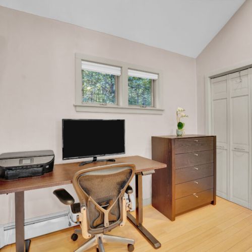 Work from Home standing desk, monitor, ergonomic chair, printer in main level king bedroom.