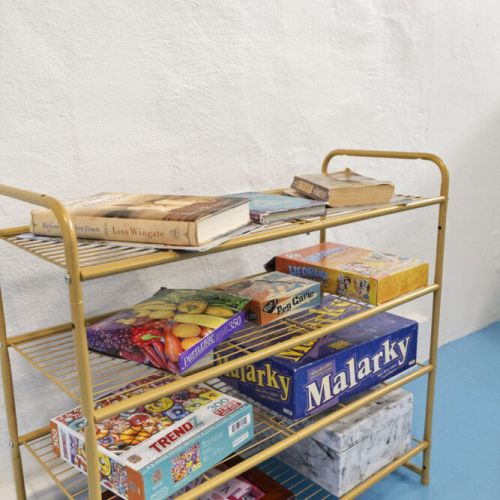 A fun selection of books and board games ready to keep guests entertained during relaxing beach days and cozy nights in.