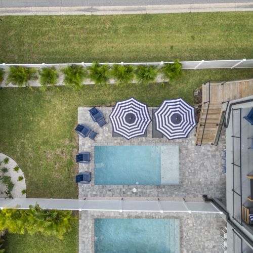 Take in the stunning aerial view of the glistening pool, your ultimate spot for relaxation and fun during your stay.
