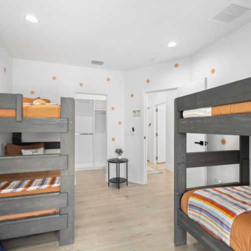 Fun, family-friendly bedroom with two sets of bunk beds perfect for kids and group stays.