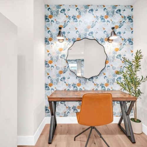 Primary bedroom features wardrobe closet, desk, leather chair, mirror, lighting. We also have a monitor and a desk mount if you want to work from home.