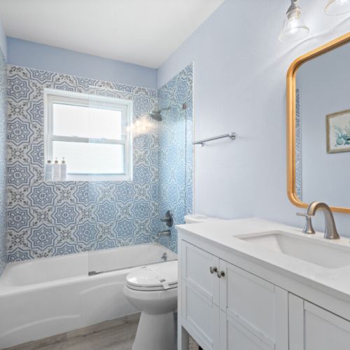 Coastal bathroom with tub and shower for a relaxing stay.