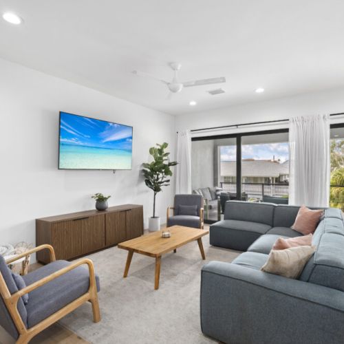 Gather in the spacious living room featuring a smart TV, perfect for movie nights or streaming your favorite shows in comfort and style.