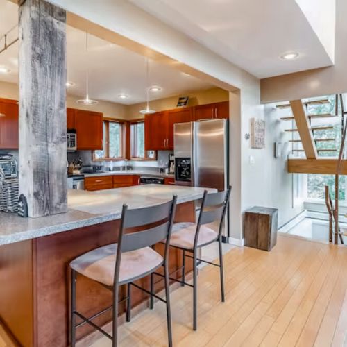 Kitchen bar, seating, rustic wood accents.