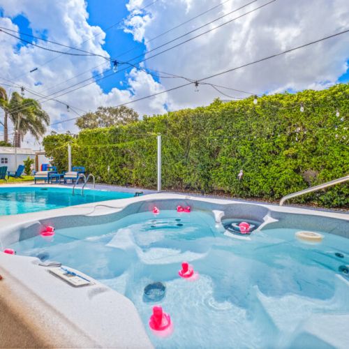 Unwind in the backyard’s bubbling hot tub, surrounded by a relaxing poolside retreat perfect for evenings under the stars.