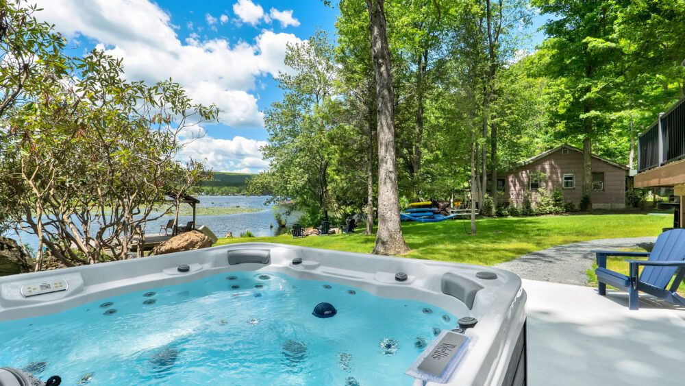Soak in the hot tub while enjoying peaceful lake views.