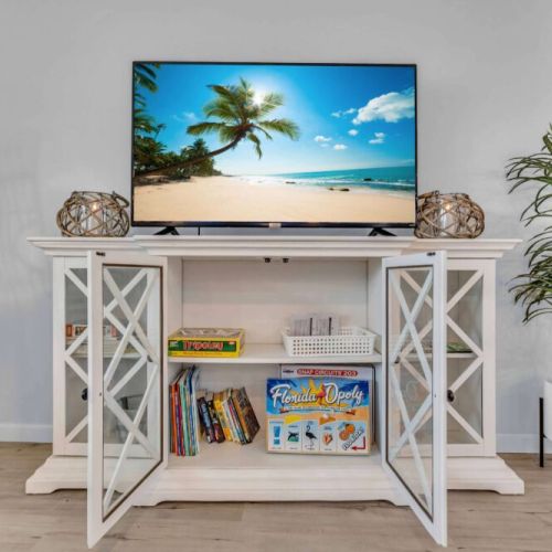 Living Room: Enjoy beach views on a large TV while lounging in a stylish chair—pure relaxation!