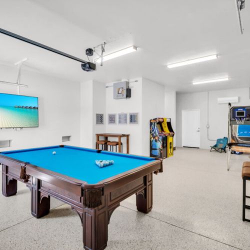 Game room - 75" tv, pool table, arcade, basketball. Perfect spot to hang out after a long day in the sun.