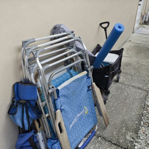 Beach chairs, wagon, cooler, and beach accessories provided for guests.