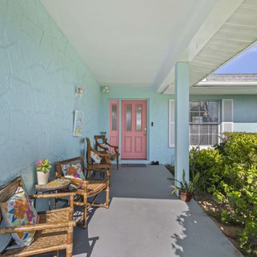 Step inside through the iconic coral door.