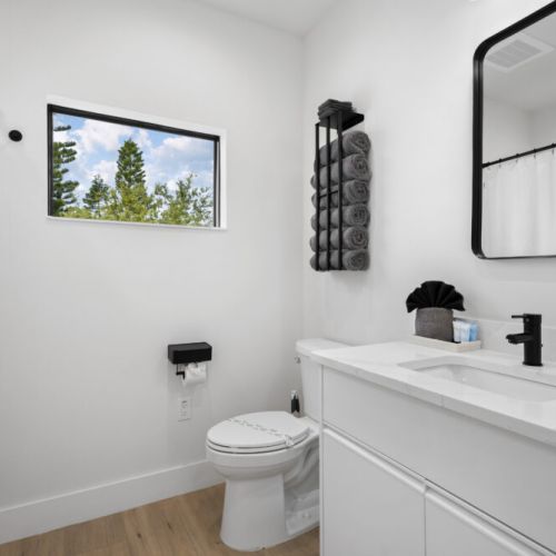 Modern third-floor bathroom with clean, stylish finishes and a relaxing shower-and-tub combo for a comfortable stay.