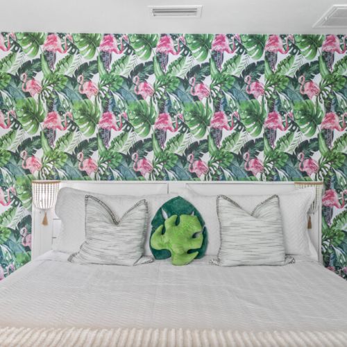 Tropical wallpaper in the master bedroom brings a vibrant, relaxing coastal vibe to your stay.