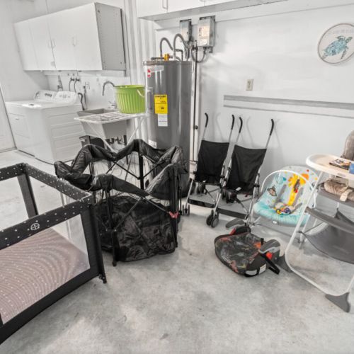 Fully stocked with baby gear including a pack n play, stroller, and high chair for a stress-free family stay.