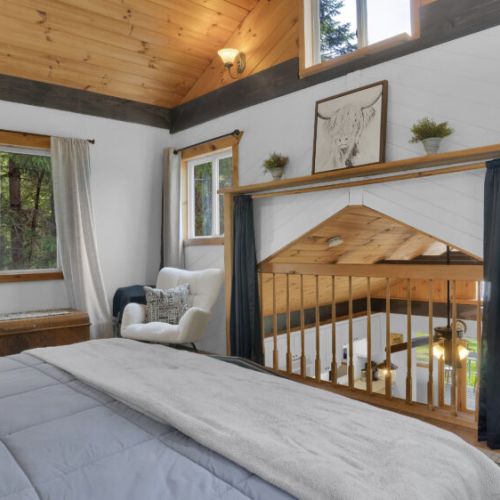 Cozy loft bedroom overlooking the warm fireplace below.