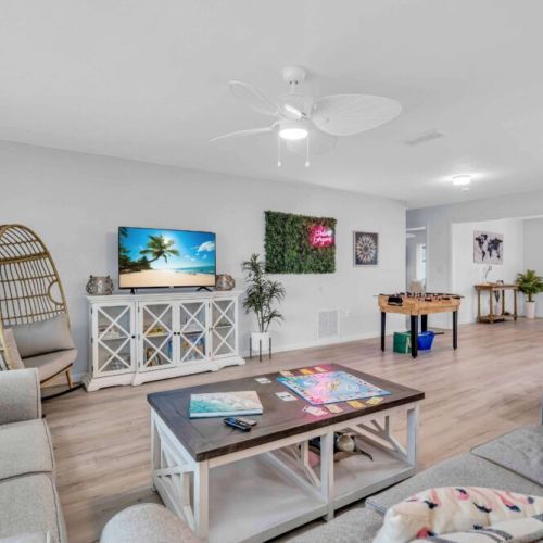 Living Room: Bright and playful space with fun games, a tropical vibe, and relaxed seating!