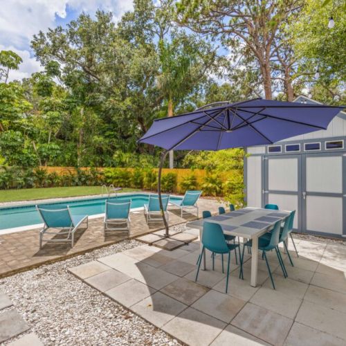 Dine alfresco! A table fit for 10 with an umbrella to cover everyone.