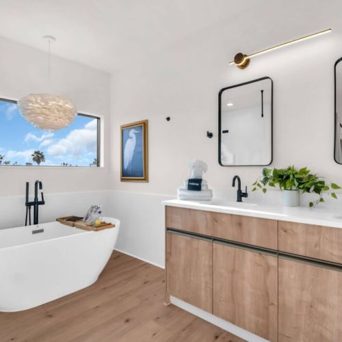 Primary bathroom features a luxury bathtub, dual sink, walk-in shower, and a water closet.